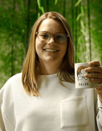 LeadVision employee posing holding up a coffee mug