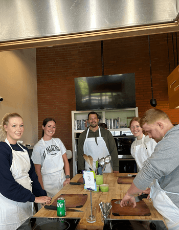 group of leadvision employees wearing aprons, ready to compete in a team bonding cookoff